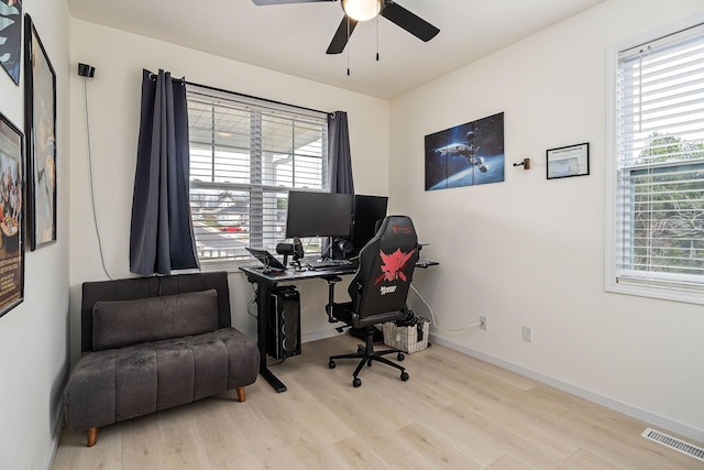 home office with ceiling fan and light hardwood / wood-style flooring