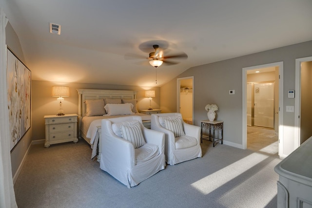 carpeted bedroom featuring ceiling fan, vaulted ceiling, a walk in closet, and a closet