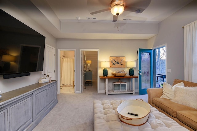 carpeted living room with ceiling fan