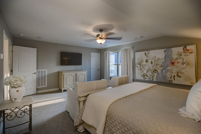 carpeted bedroom with vaulted ceiling and ceiling fan