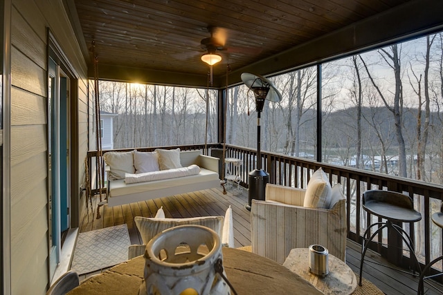 deck with baseboard heating, ceiling fan, and an outdoor living space