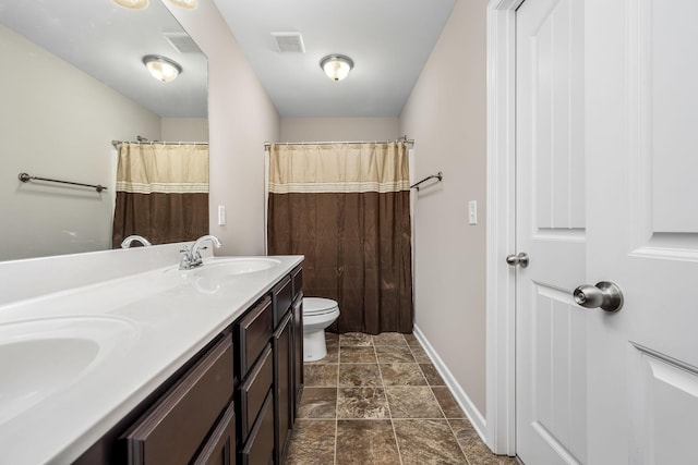 bathroom featuring vanity, toilet, and walk in shower