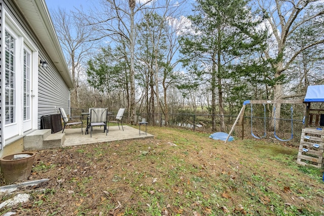 view of yard featuring central AC unit, a patio area, and a playground