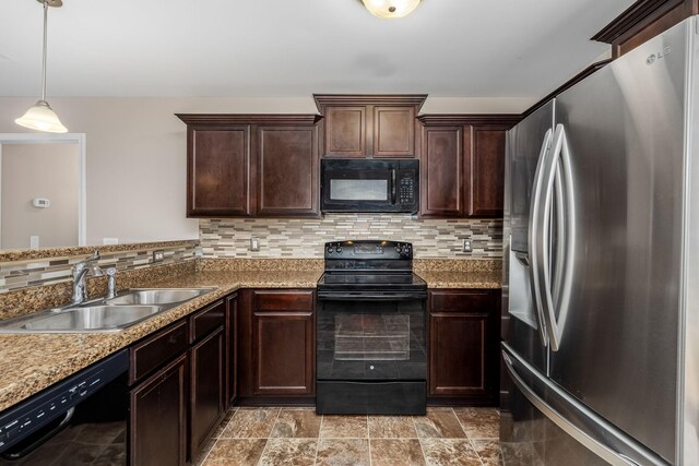 kitchen with pendant lighting, decorative backsplash, sink, and black appliances