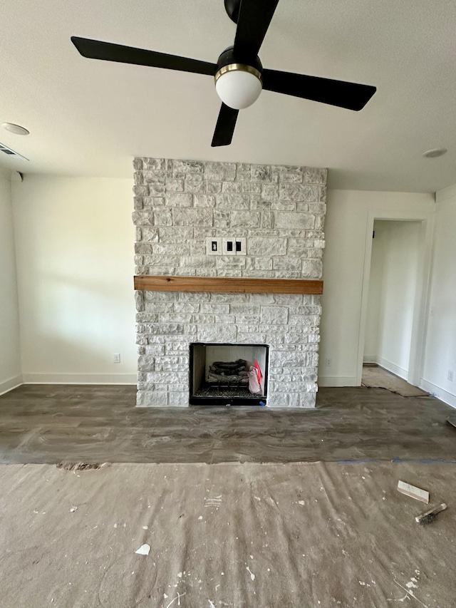 unfurnished living room featuring ceiling fan, hardwood / wood-style floors, a textured ceiling, and a fireplace