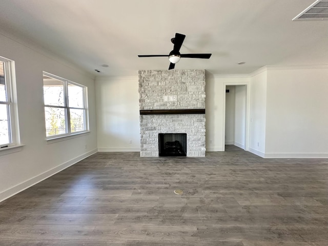 unfurnished living room featuring visible vents, a stone fireplace, baseboards, and wood finished floors