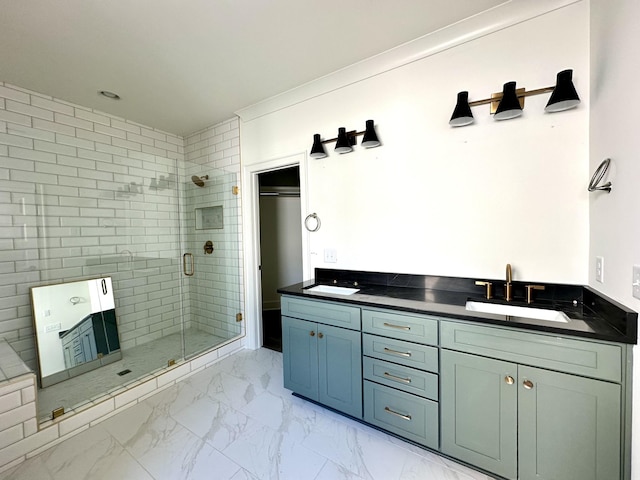 bathroom with marble finish floor, double vanity, a sink, and a shower stall