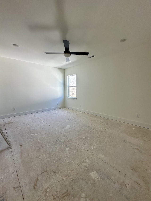 empty room featuring visible vents, ceiling fan, and baseboards