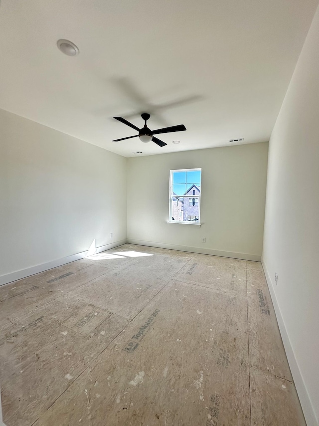 unfurnished room featuring visible vents, ceiling fan, and baseboards