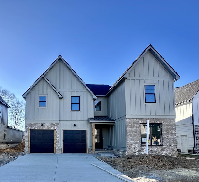 modern inspired farmhouse featuring a standing seam roof, a garage, brick siding, driveway, and board and batten siding