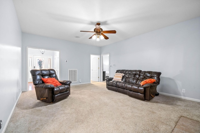 carpeted living room with ceiling fan