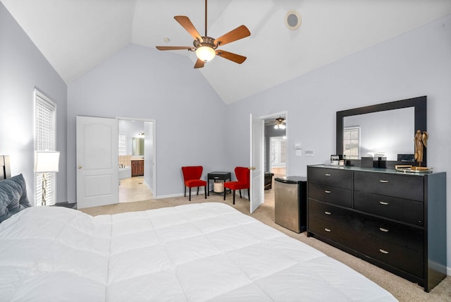 bedroom featuring connected bathroom, light carpet, stainless steel fridge, high vaulted ceiling, and ceiling fan