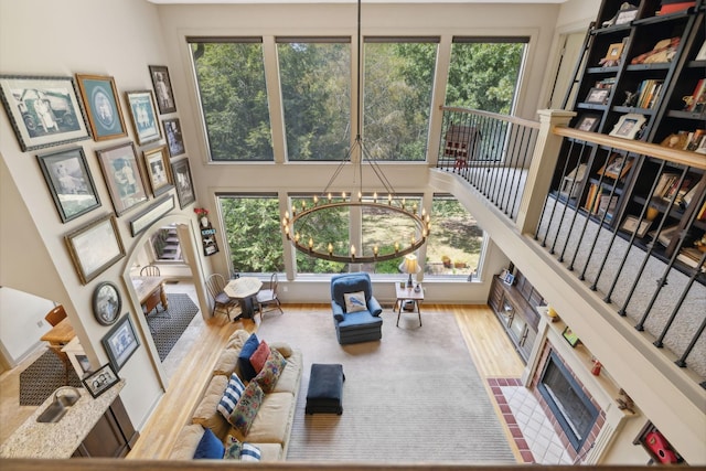 living room with hardwood / wood-style floors, an inviting chandelier, and a healthy amount of sunlight