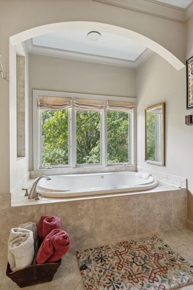 bathroom featuring tile patterned floors, a relaxing tiled tub, a healthy amount of sunlight, and crown molding