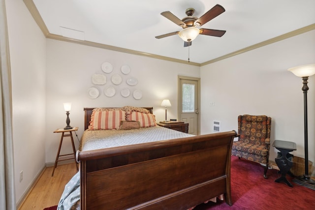 bedroom with hardwood / wood-style floors, ceiling fan, and crown molding