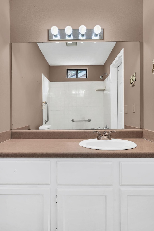 bathroom with vanity and walk in shower