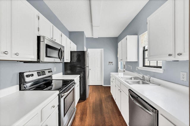 kitchen featuring white cabinets, stainless steel appliances, dark hardwood / wood-style floors, and sink