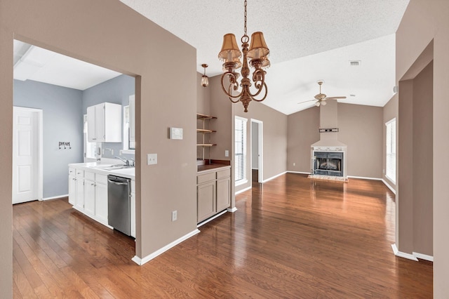 kitchen with dark hardwood / wood-style floors, plenty of natural light, lofted ceiling, and sink