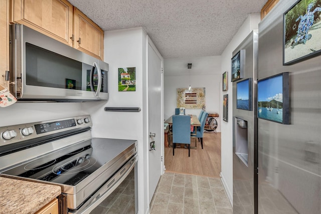 kitchen featuring stainless steel appliances and a textured ceiling