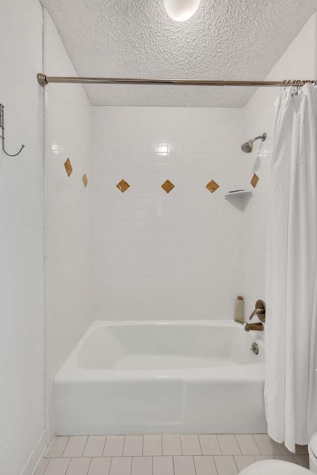 bathroom with tile patterned floors, toilet, and a textured ceiling