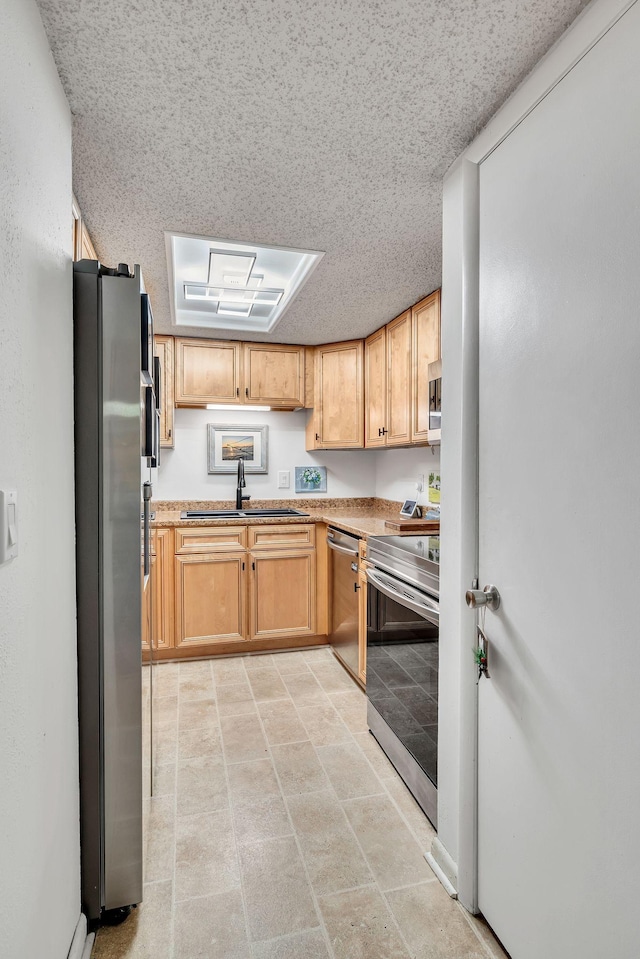 kitchen with appliances with stainless steel finishes and sink