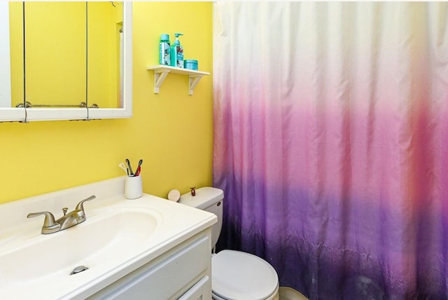 bathroom featuring vanity and toilet