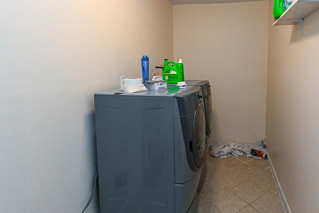 washroom with washer and dryer and light tile patterned flooring