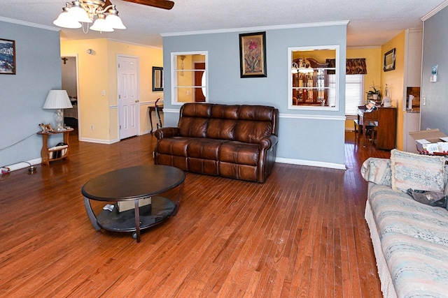 living room with wood-type flooring, ornamental molding, and ceiling fan