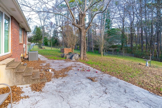 view of yard featuring a patio and central AC unit