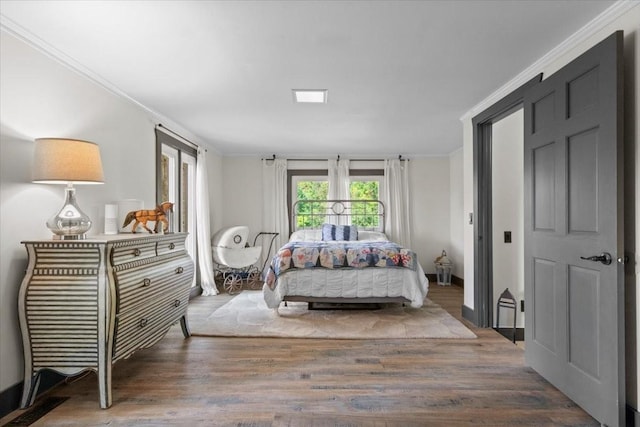 bedroom with crown molding and hardwood / wood-style flooring