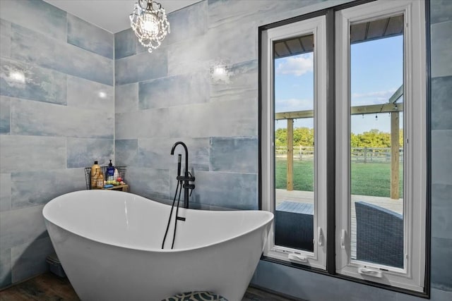 bathroom with a bath, tile walls, and wood-type flooring