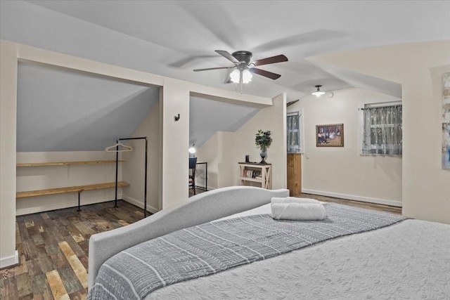 bedroom featuring ceiling fan, dark wood-type flooring, and vaulted ceiling