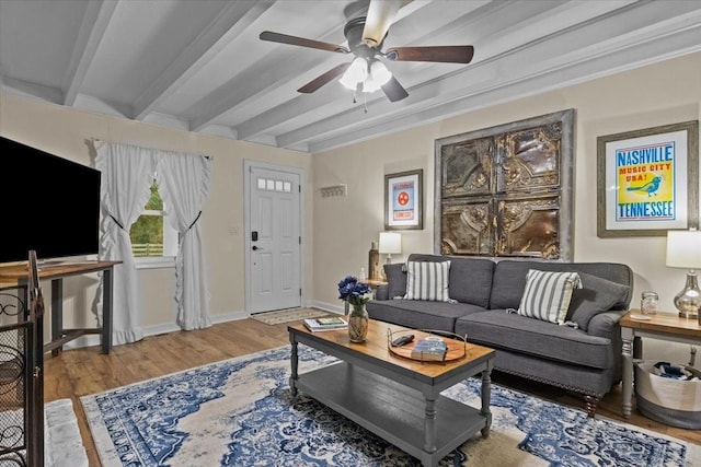 living room with beam ceiling, hardwood / wood-style flooring, ceiling fan, and crown molding