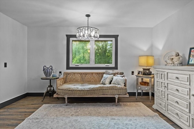 living area with a notable chandelier and dark hardwood / wood-style flooring