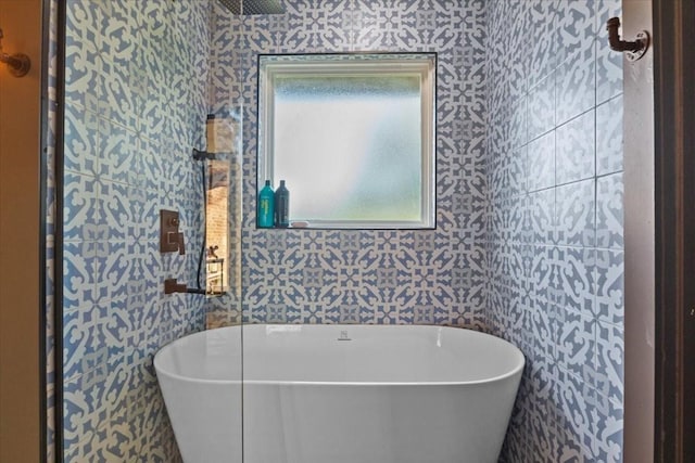 bathroom with a bath and tile walls