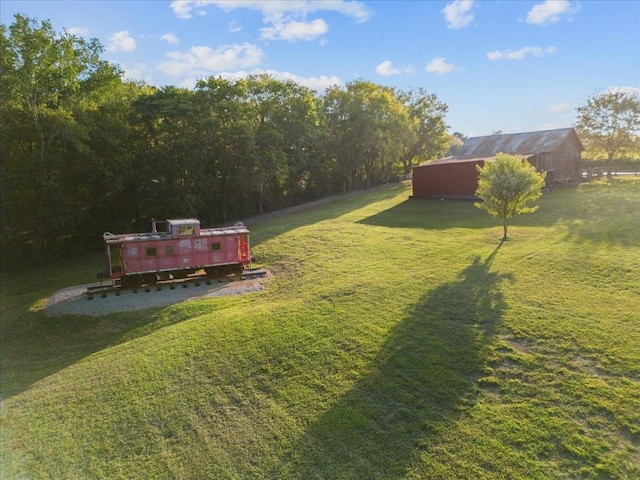 view of yard featuring a deck and an outdoor structure