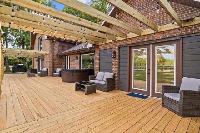 wooden terrace with a pergola and a hot tub