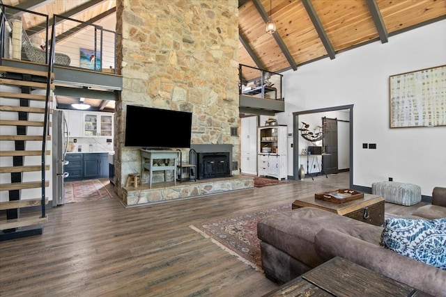 living room with wooden ceiling, a wood stove, high vaulted ceiling, beamed ceiling, and dark hardwood / wood-style flooring