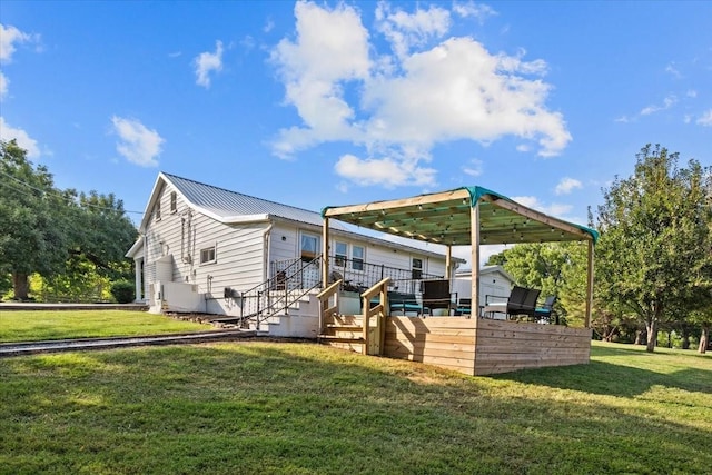 rear view of property featuring a yard