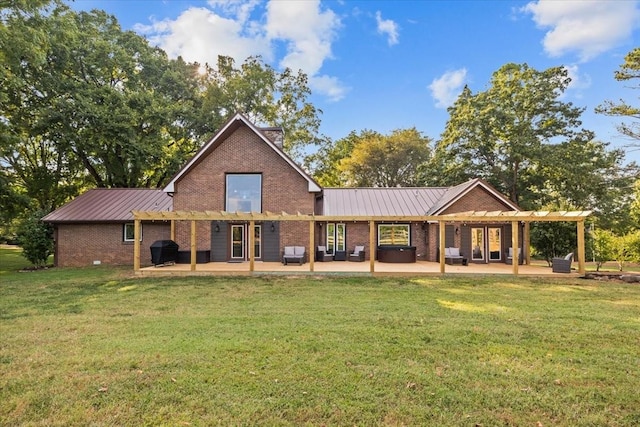 back of house featuring a yard, a patio, and a pergola