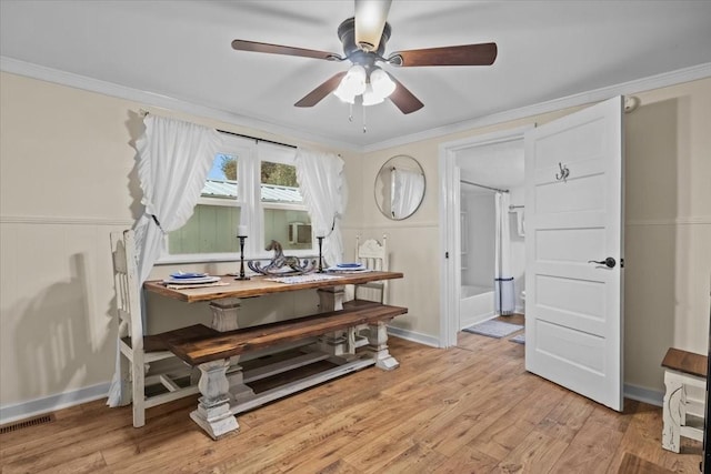 dining room featuring ceiling fan, crown molding, and light hardwood / wood-style flooring