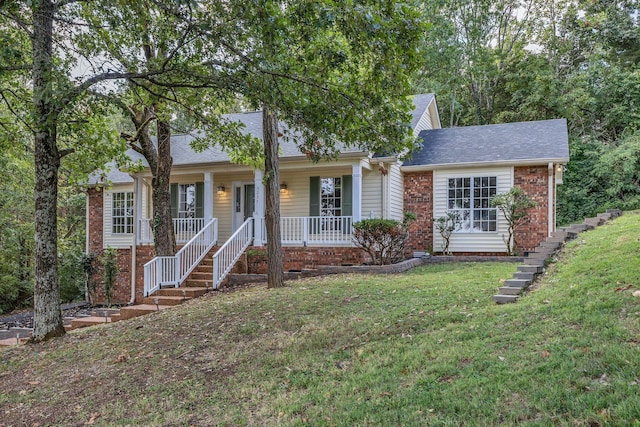 view of front of house featuring covered porch and a front yard