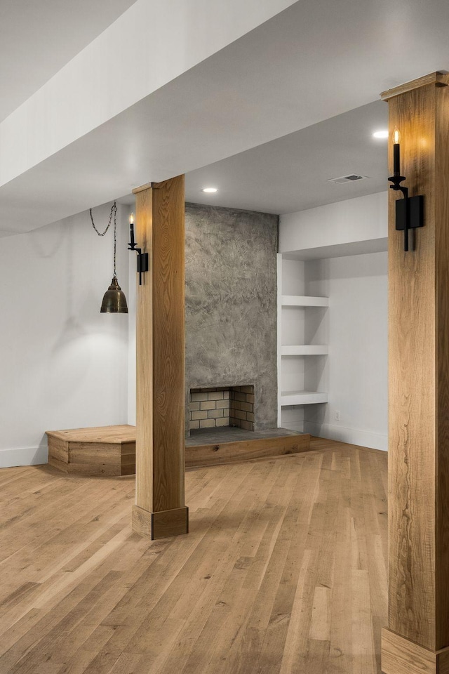 basement with a fireplace and hardwood / wood-style flooring