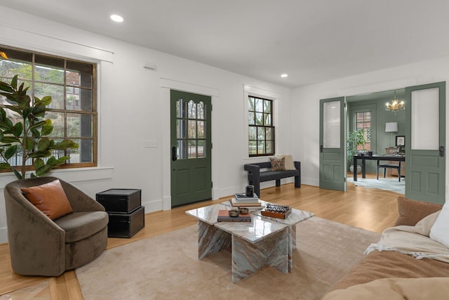 living room featuring a notable chandelier and light hardwood / wood-style floors