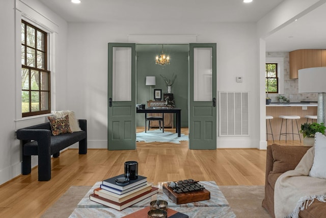 living room with hardwood / wood-style flooring and a chandelier