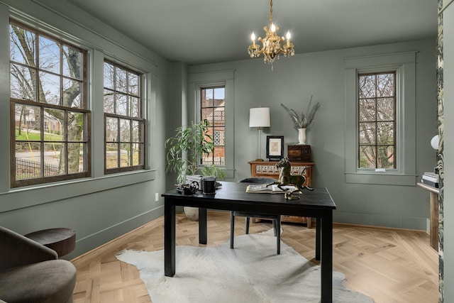 home office with an inviting chandelier and light parquet floors