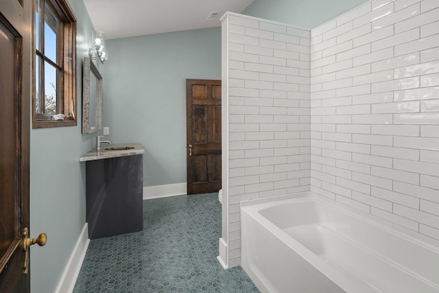 bathroom with vanity and a tub