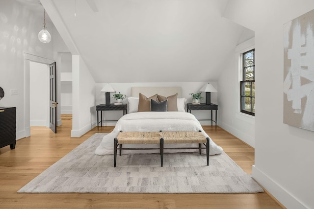 bedroom featuring lofted ceiling and hardwood / wood-style floors