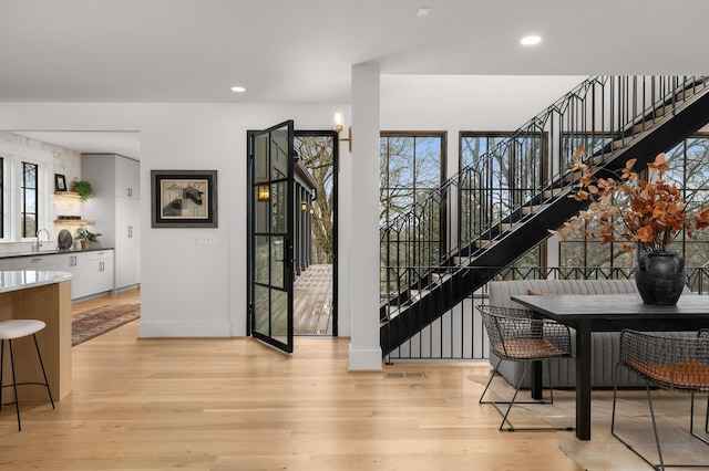 interior space with sink, a wealth of natural light, and light hardwood / wood-style floors