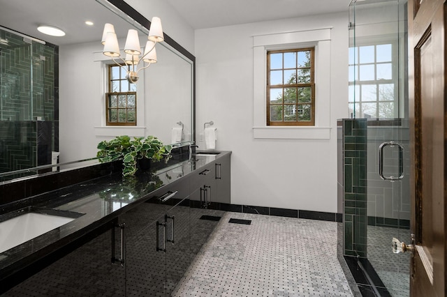 bathroom featuring tile patterned floors, plenty of natural light, a shower with door, and vanity